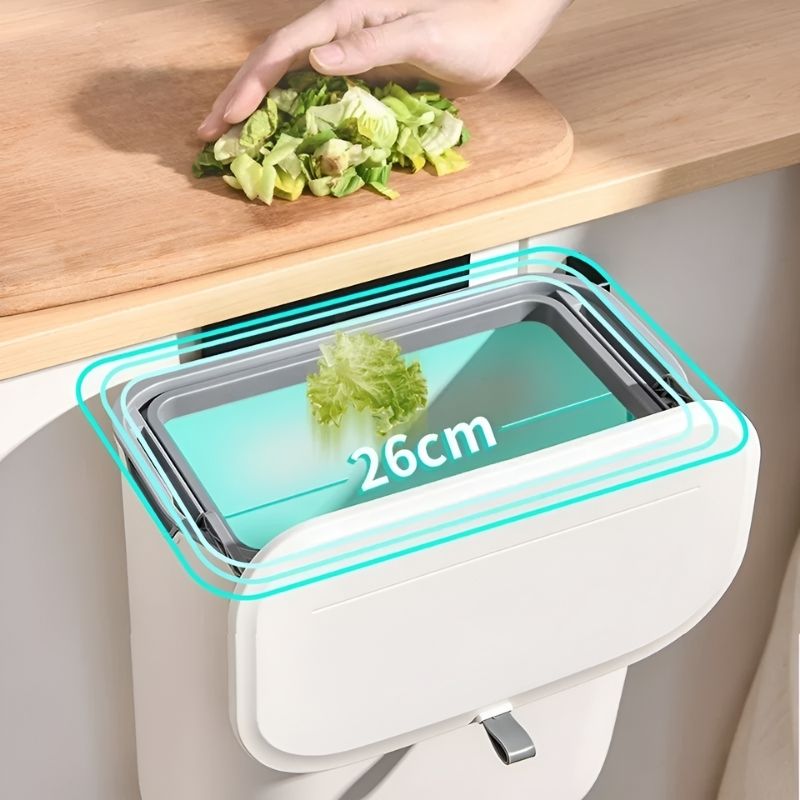 Compacte HydroBin™ in actie: een handsfree afvalbak van 26 cm breed, ideaal voor keukenrestjes. Perfect te monteren aan je aanrecht voor efficiënte afvalverwerking.
