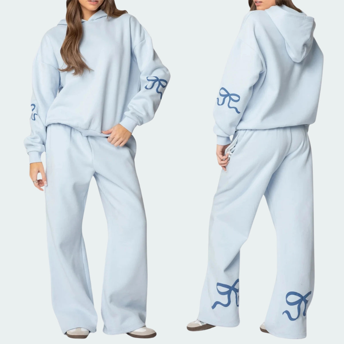 Luna Ribbon Tracksuit - Elegantie in Comfort Witte tracksuit met zachte blauwe strikaccenten op mouwen en broekspijpen. Ideaal voor een frisse, casual look. Shop exclusief o